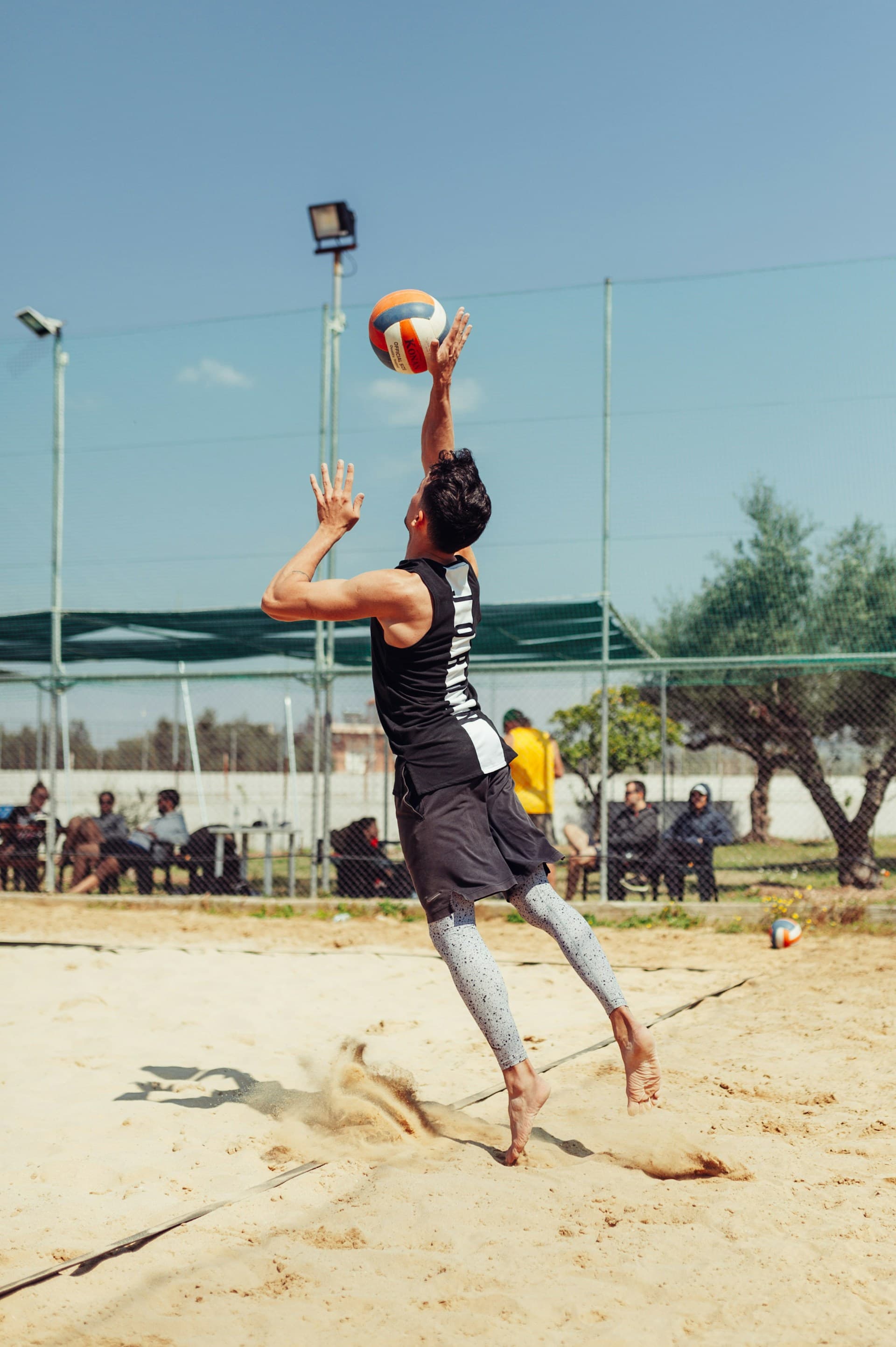 Sand volleyball player reaching for the ball